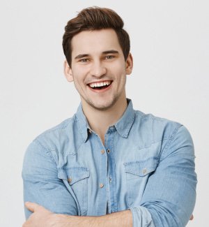 Happy young man with arms crossed