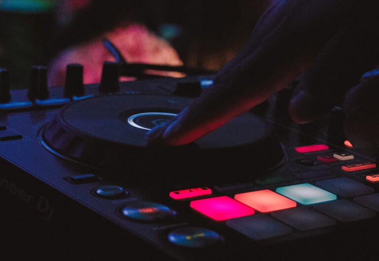 DJ's hand on Pioneer DJ controller, illuminated buttons
