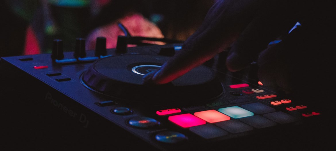 DJ's hand on Pioneer DJ controller, illuminated buttons