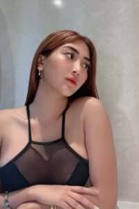 Attractive young woman in a black mesh top.