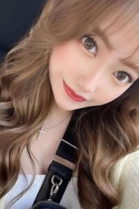 Close-up portrait of a young woman with long brown hair.